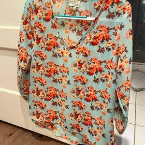 Blue floral print blouse with button detail on sleeve